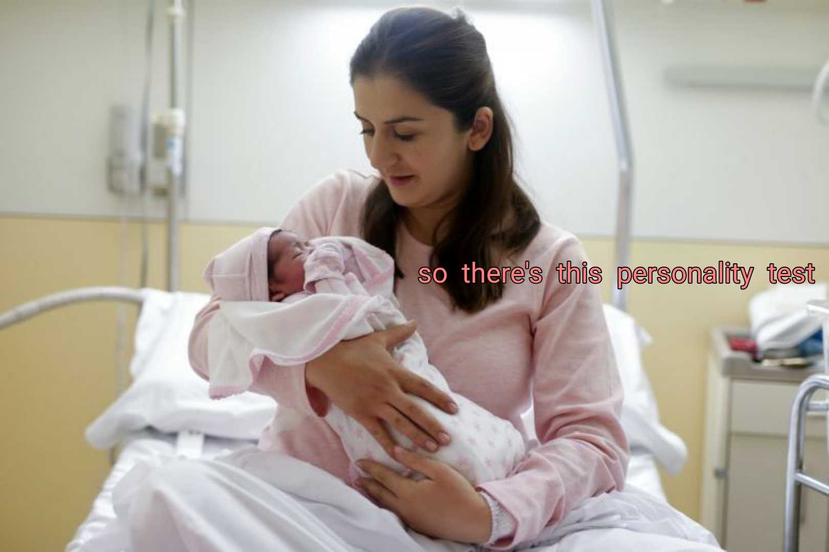 there is a woman holding a baby in a hospital bed