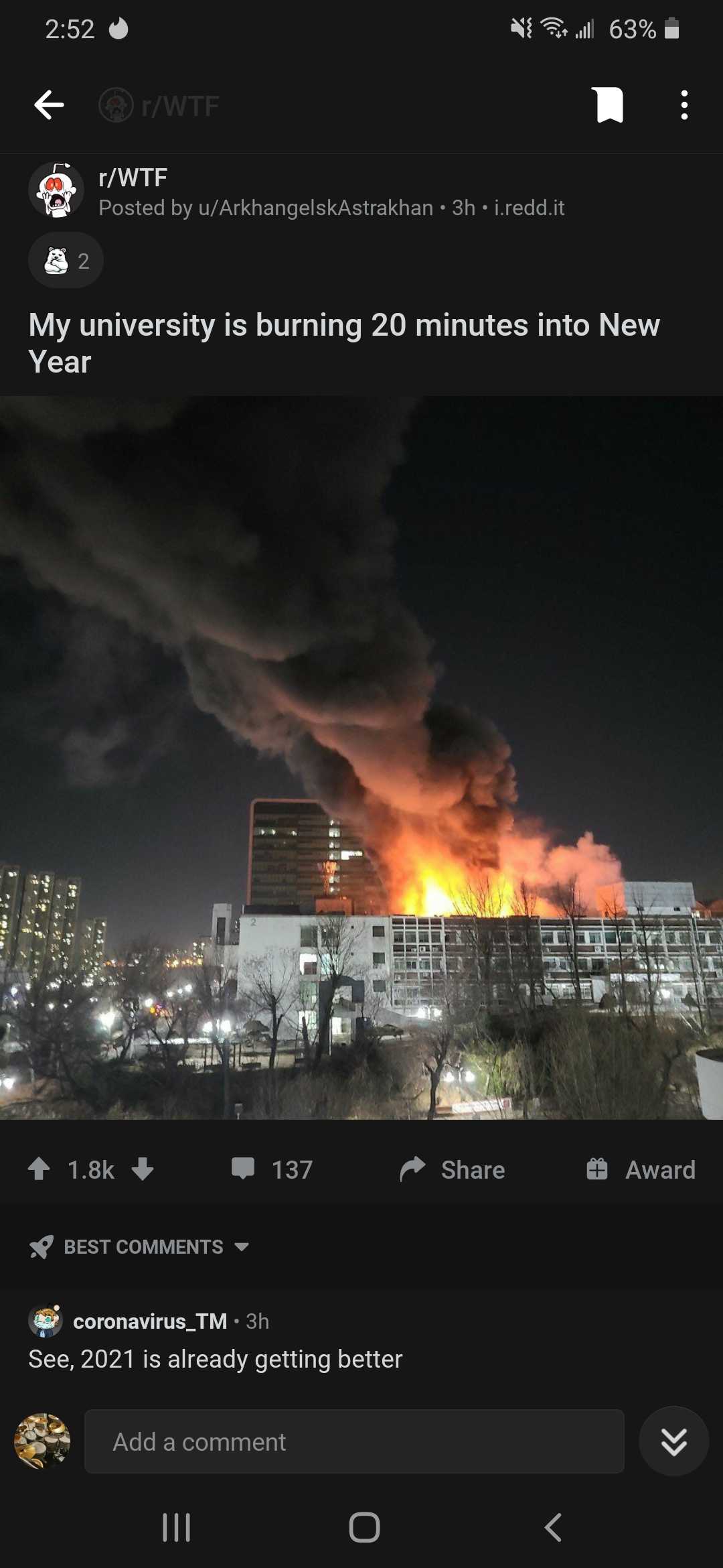 a close up of a fire in a building with a sky background