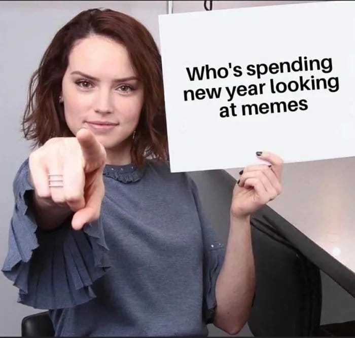 woman holding up a sign that says who ' s spending new year looking at memes