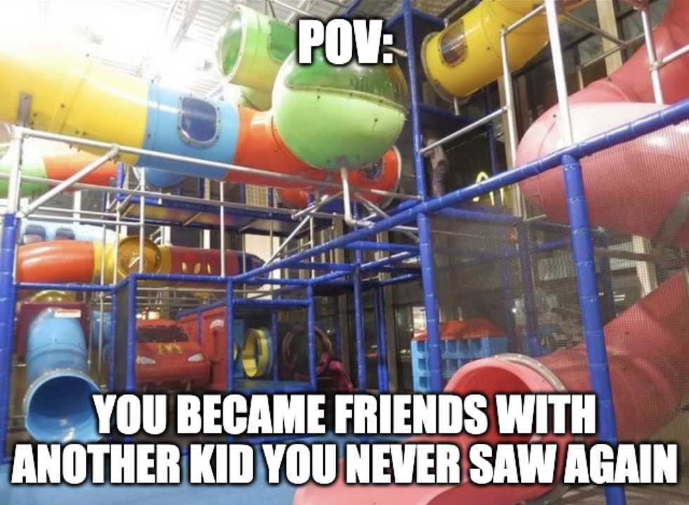 a close up of a playground with a slide and a child on it