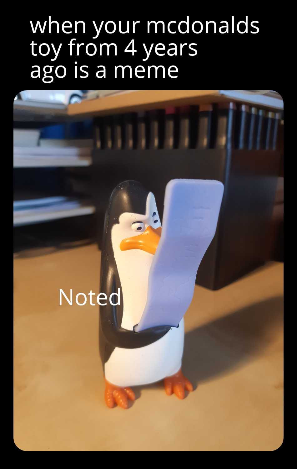 penguin holding a piece of paper with the caption of a note