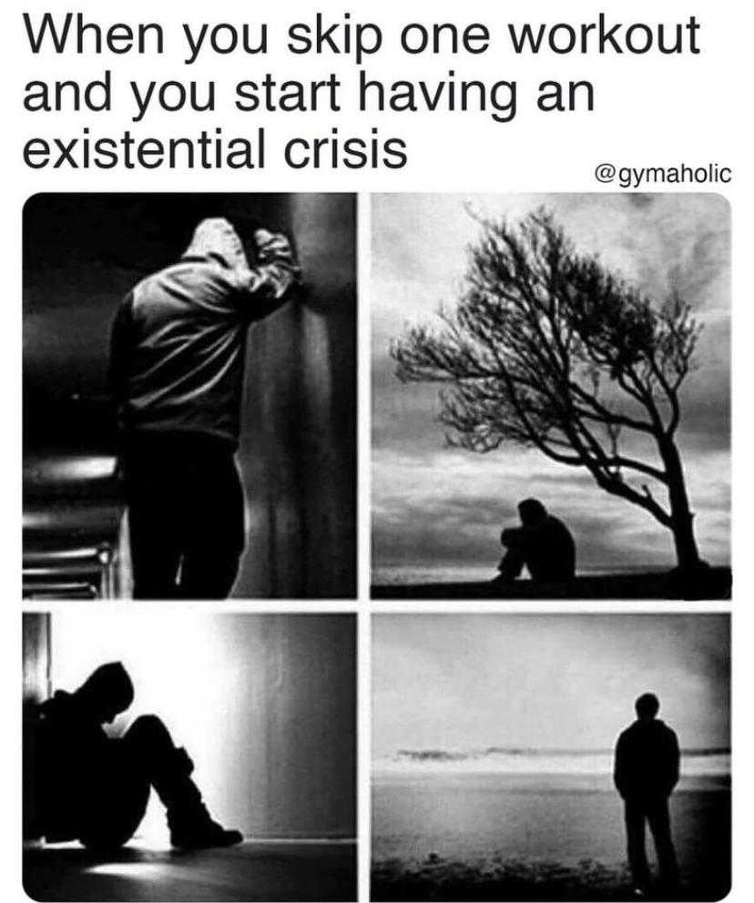 a black and white photo of a man sitting on the ground next to a tree