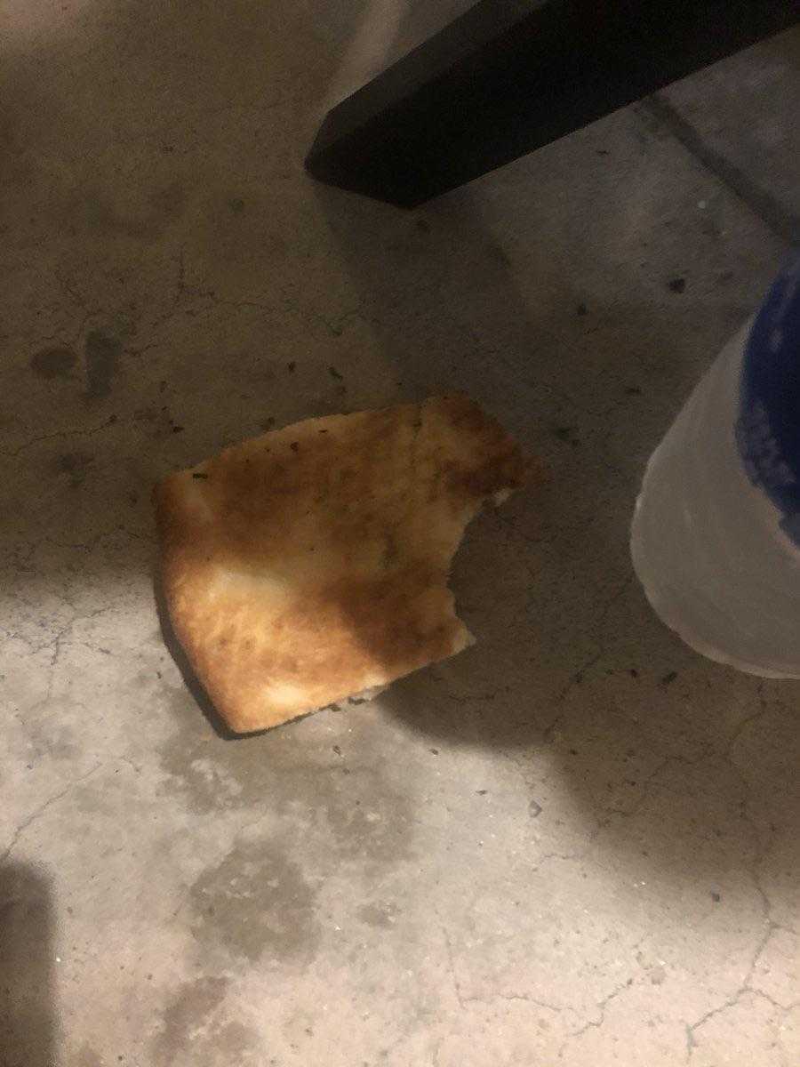 there is a piece of bread that is on the floor