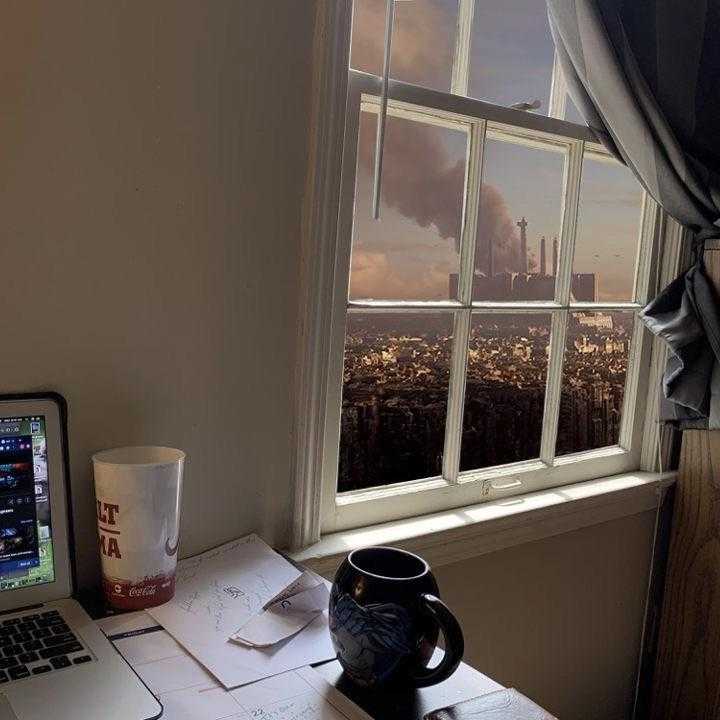 laptop computer sitting on a desk in front of a window