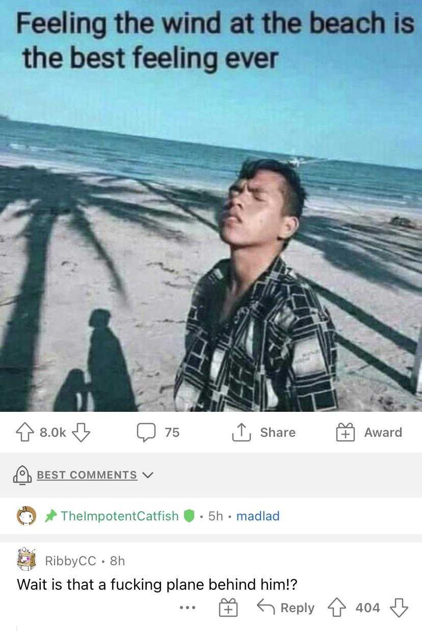 a close up of a person standing on a beach near the ocean