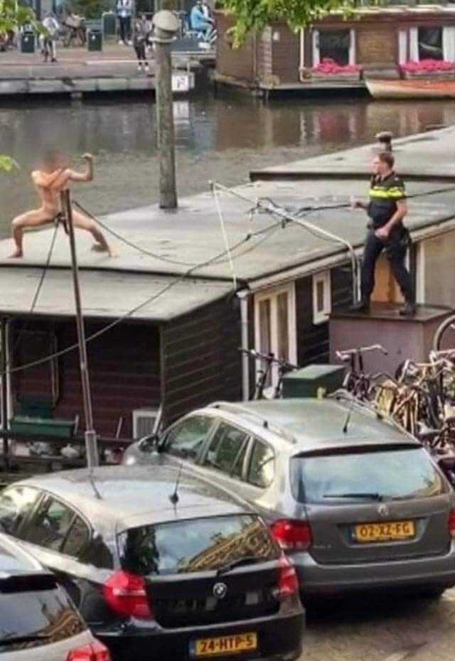 cars parked on the side of a road next to a body of water