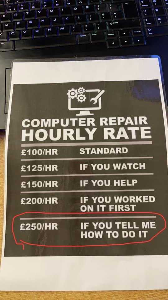 a close up of a computer repair sign on a desk