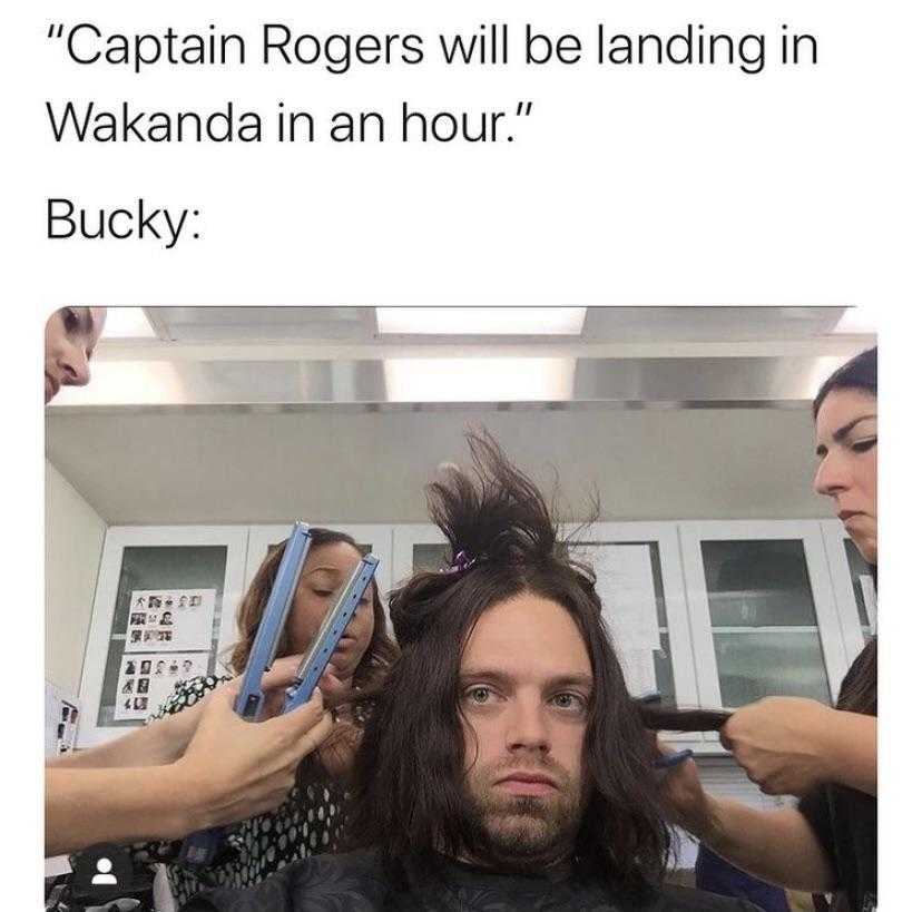 man with long hair in a barber shop getting his hair cut