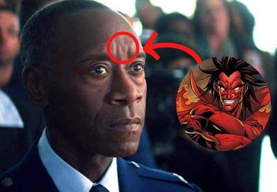 a close up of a man in a uniform with a red arrow pointing to the head of a demon