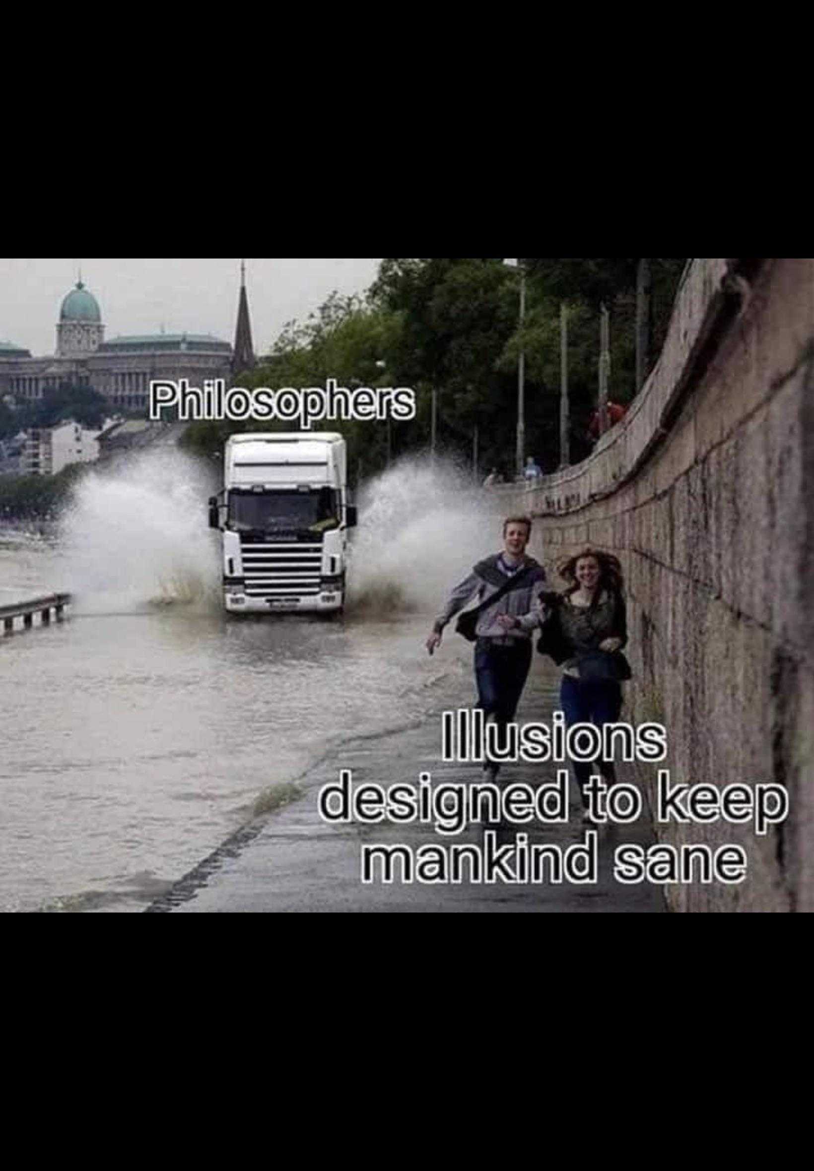 truck driving through a flooded street with a man standing next to it