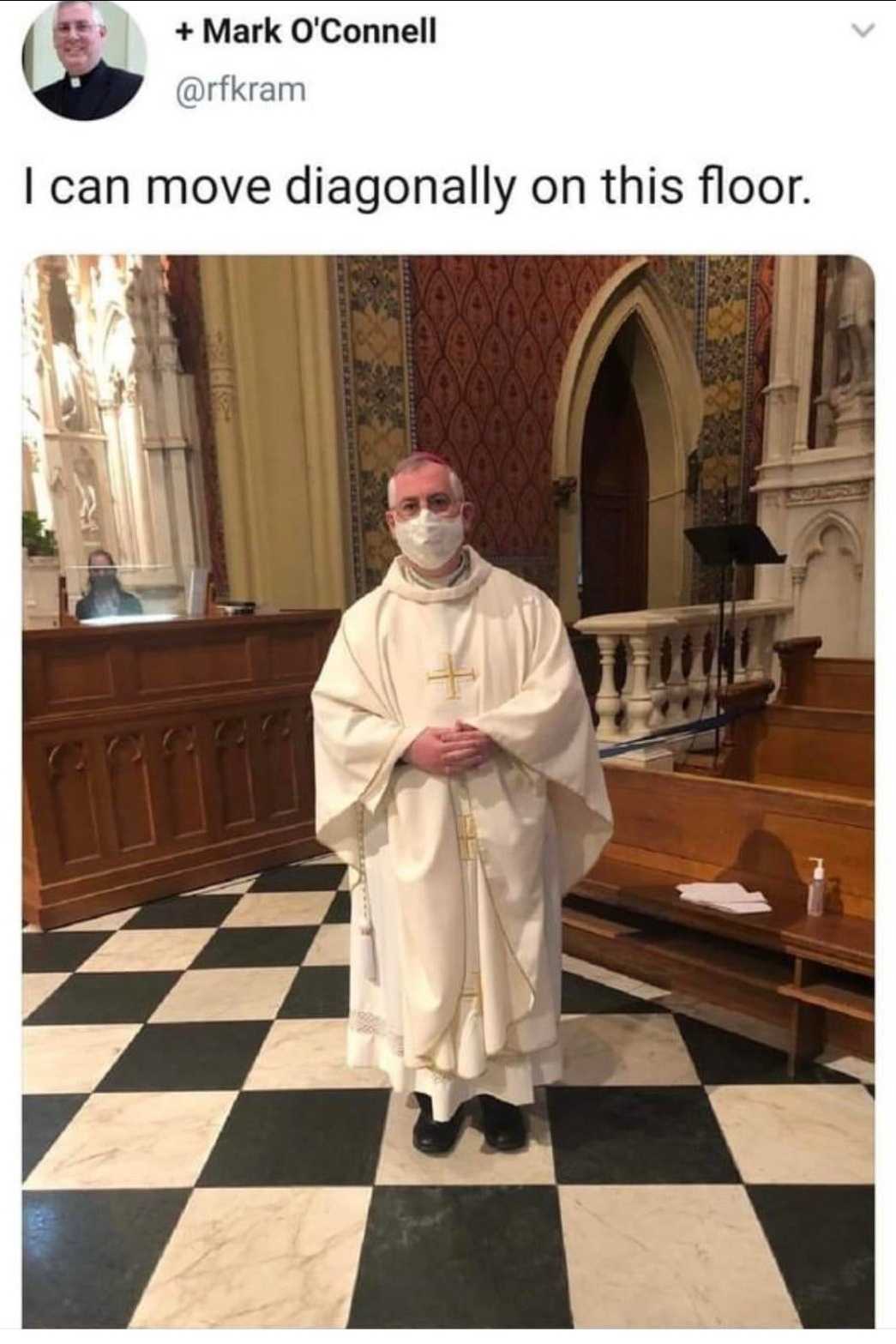 priest in a white robe standing in a church