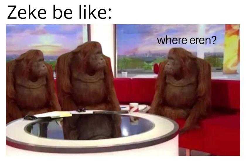 there are three monkeys sitting on a red couch in a room