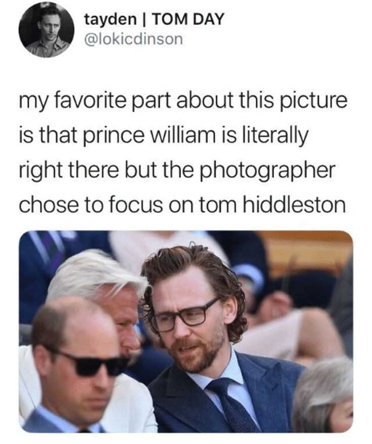 a close up of a person in a suit and tie with a camera