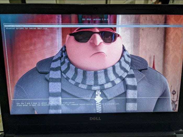 image of a man wearing sunglasses and a scarf on a laptop