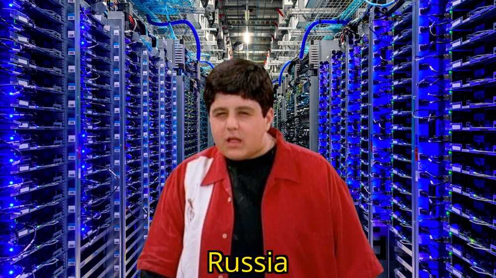 image of a man in a red jacket standing in a server room