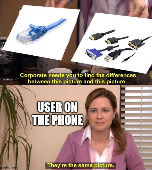 a close up of a person holding a cell phone near a computer