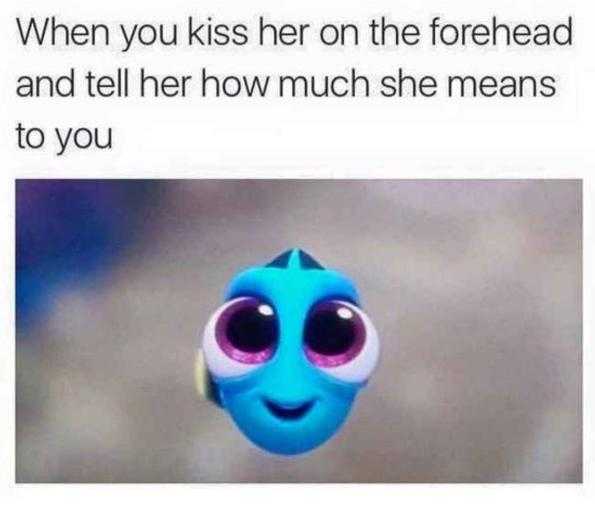 a close up of a blue fish with big eyes and a caption that reads, when you kiss her on the forehead and tell her how much she means to you