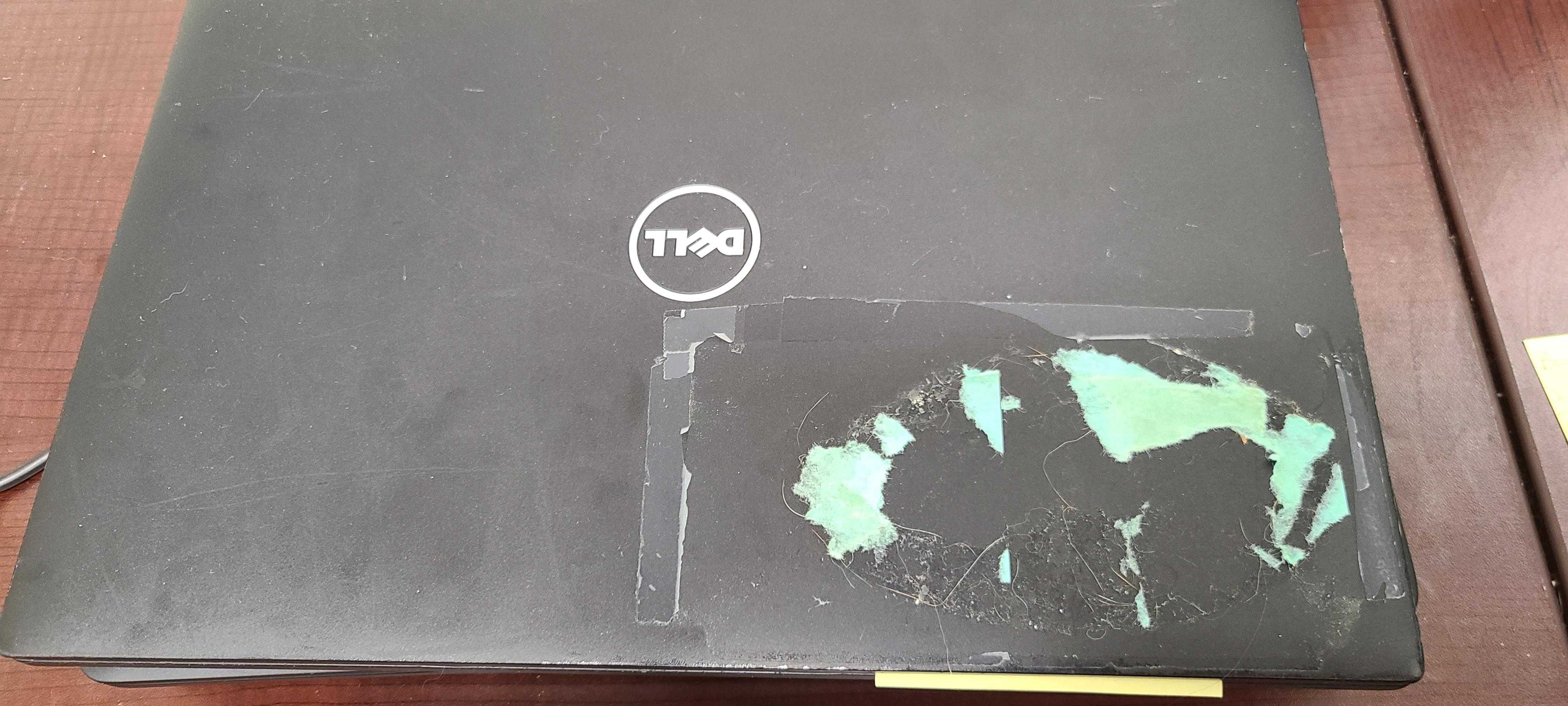 there is a laptop with a sticker on it sitting on a table