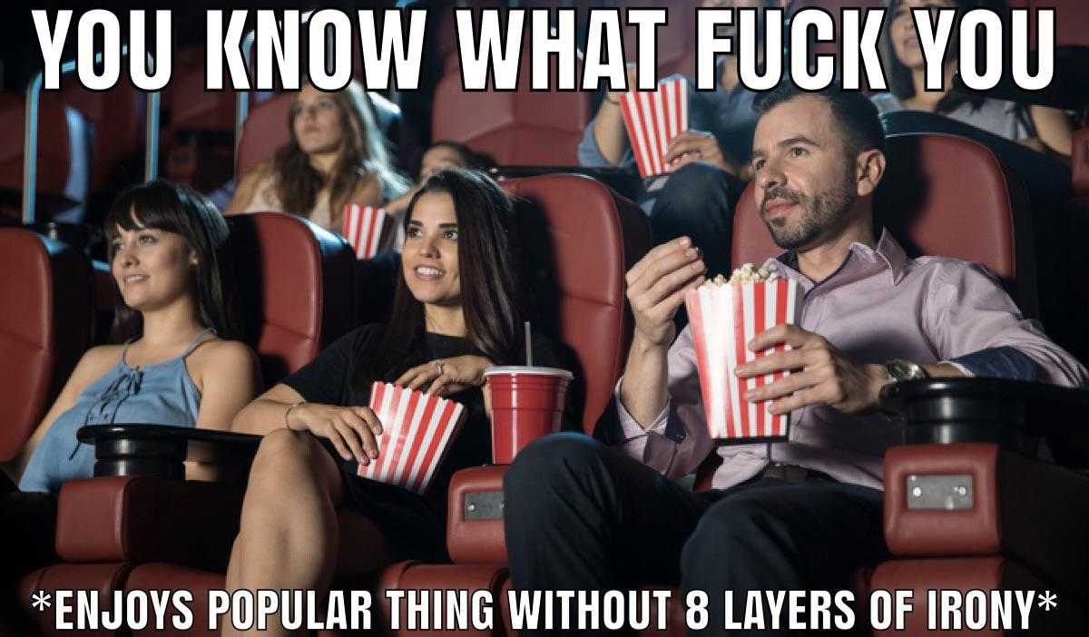 people sitting in a movie theater watching a movie and eating popcorn