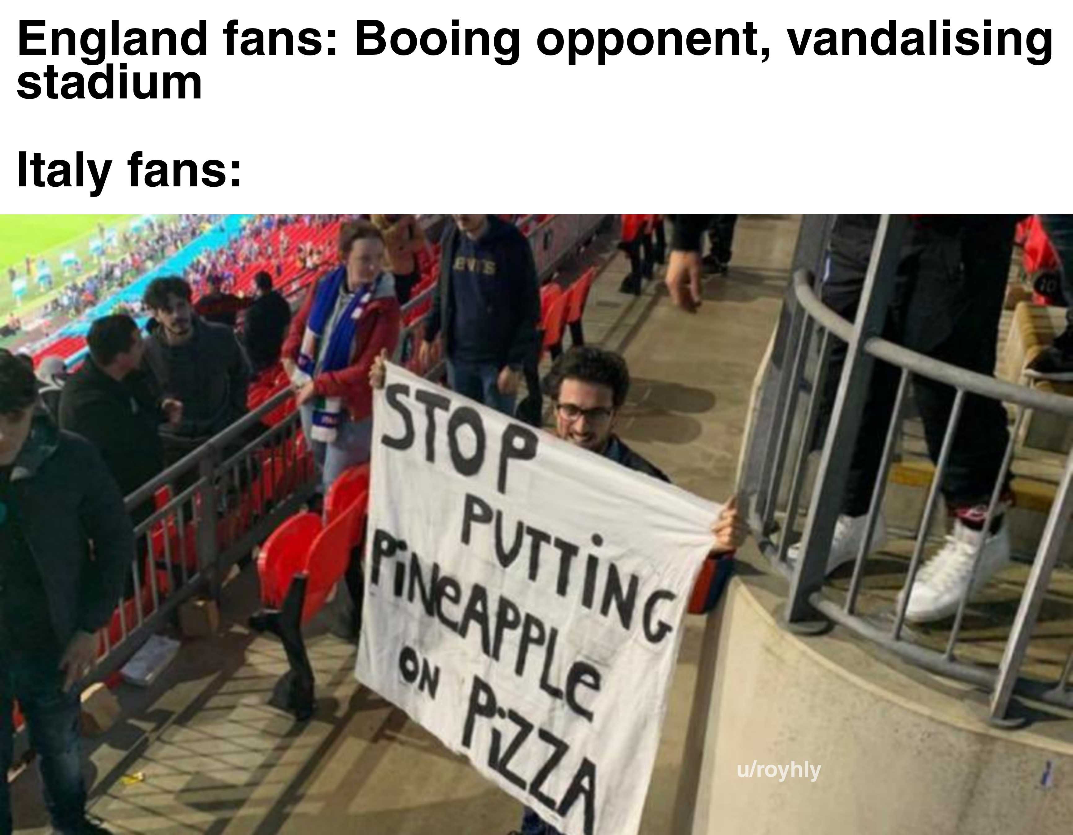 banner in a stadium with a man holding a sign