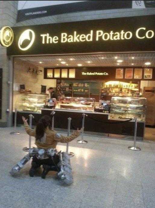 woman sitting on a bench in front of a bakery