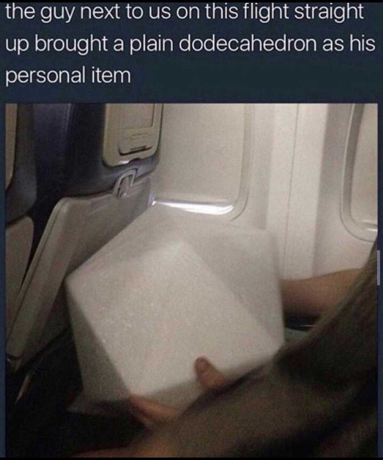 someone is holding a box of food on an airplane