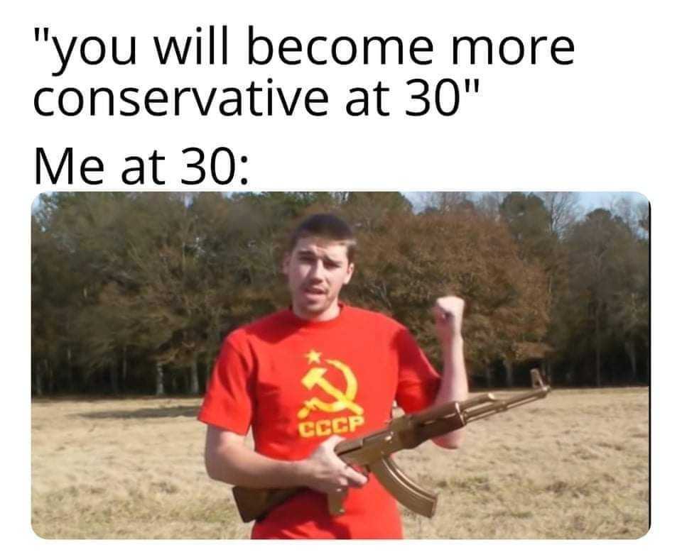 man holding a rifle in a field with a hammer in his hand