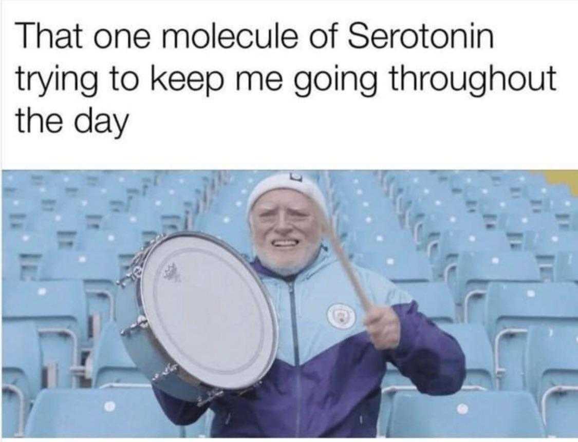 man in a stadium holding a drum and a drum stick