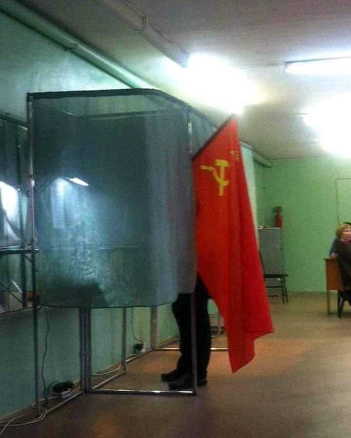 there is a man standing behind a glass screen with a flag