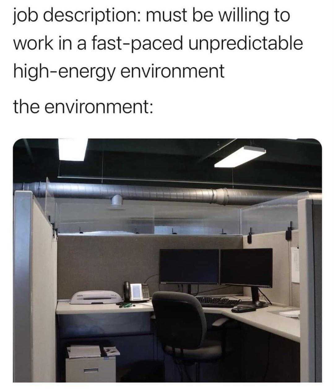 office cubicle with a computer desk and a monitor