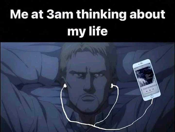 image of a man laying in bed with headphones on and a cell phone in his hand