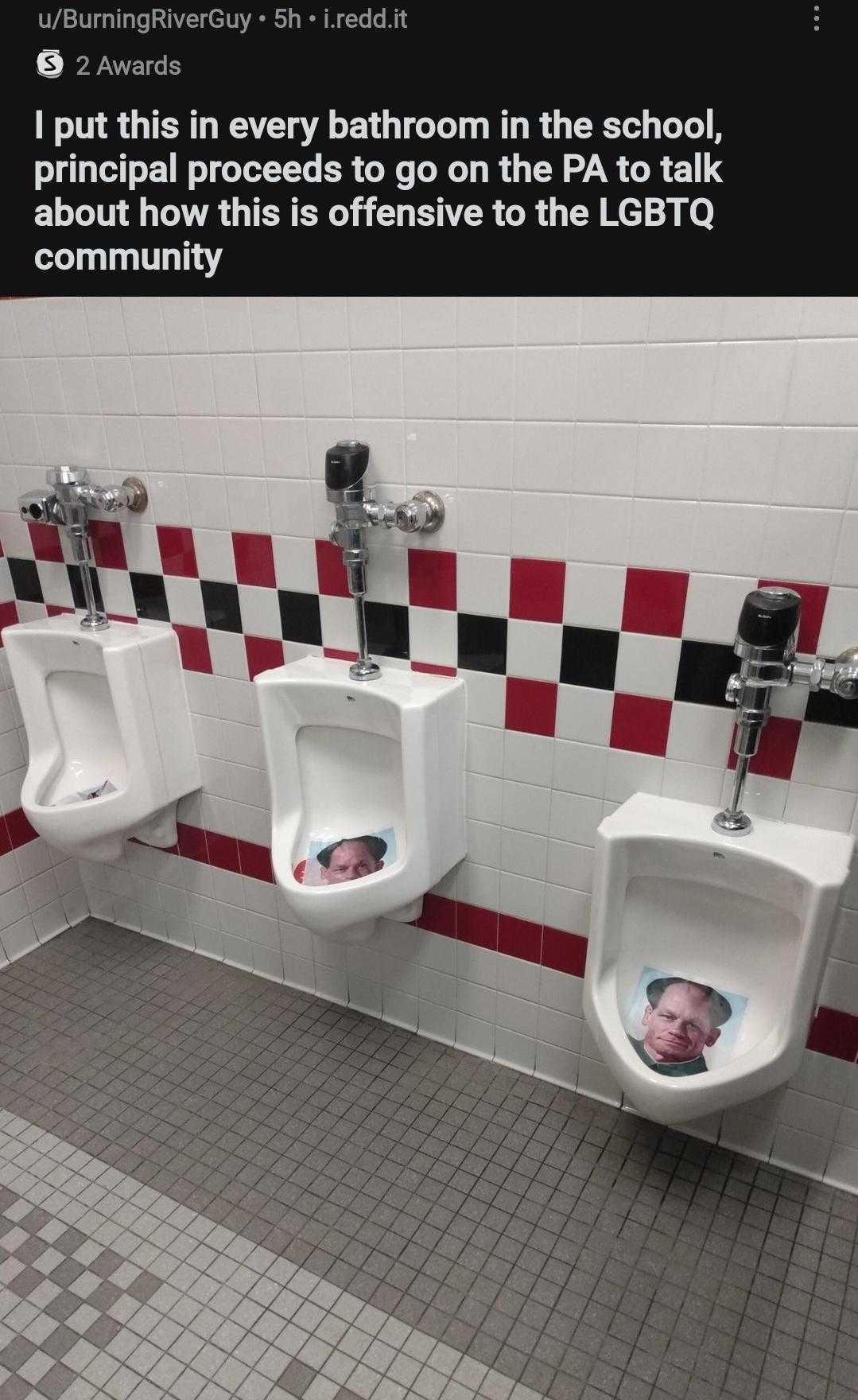 there are three urinals in a bathroom with a picture of a baby