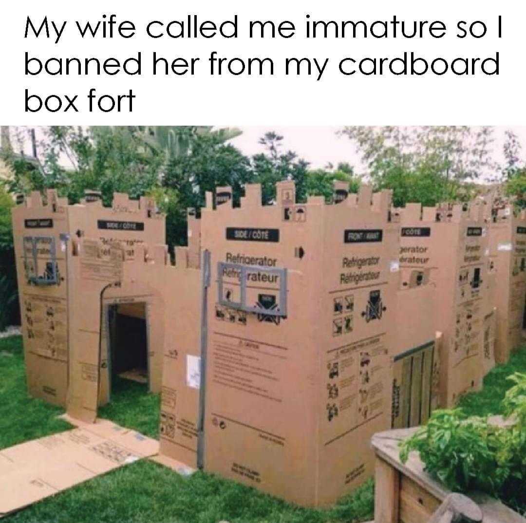 cardboard castle with a door and a sign on the front