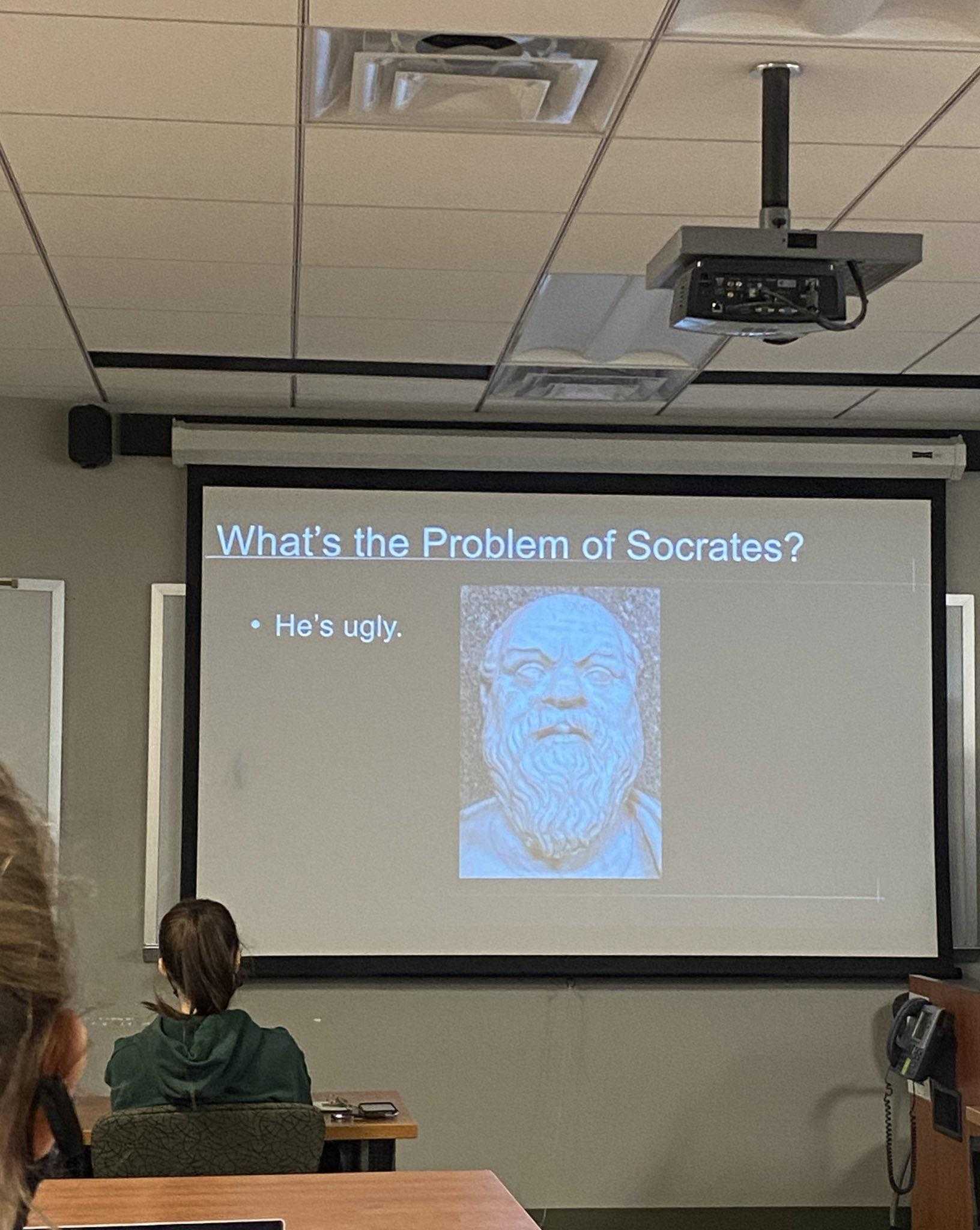 there is a man standing in front of a projector screen giving a presentation