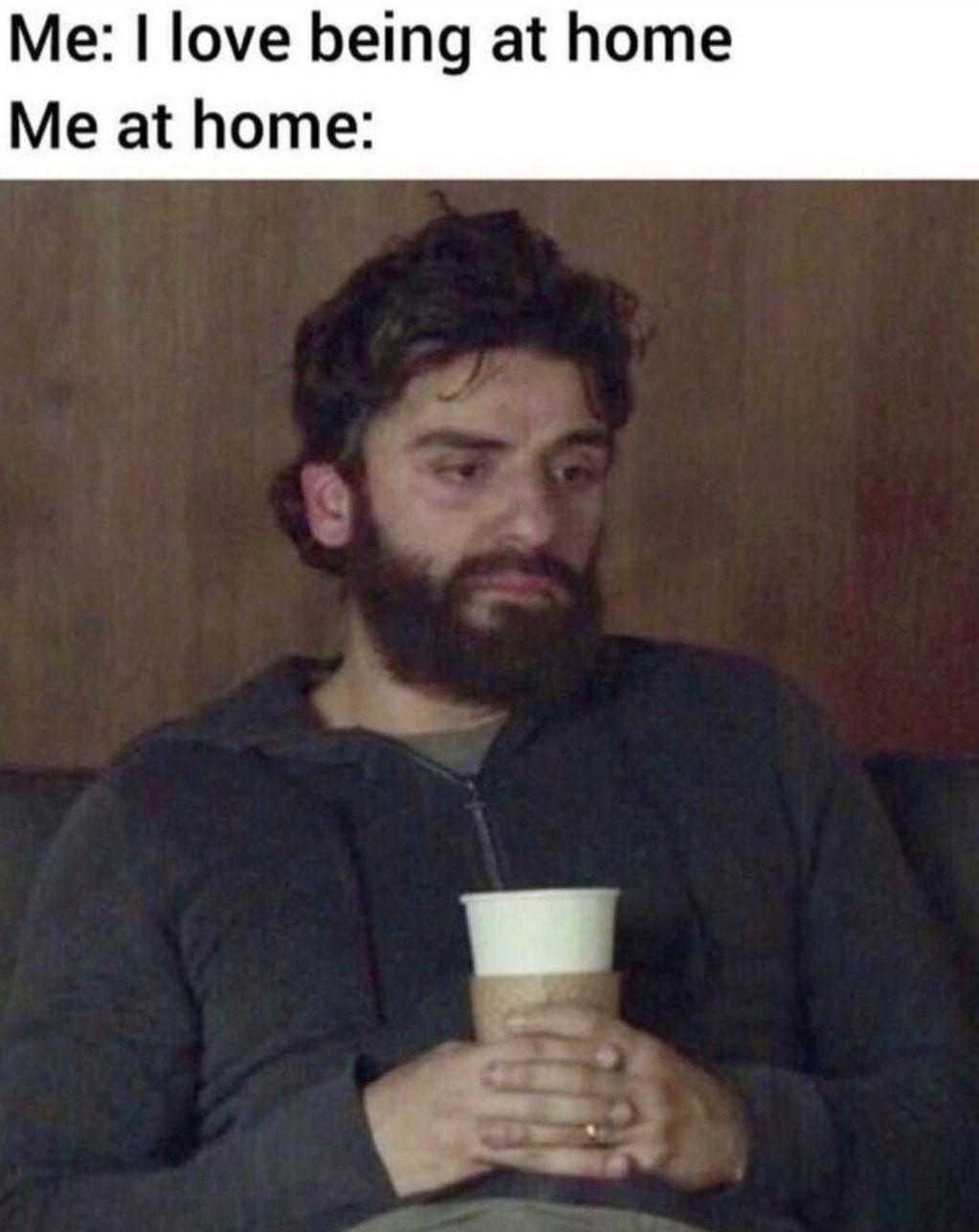 man sitting on a couch holding a cup of coffee