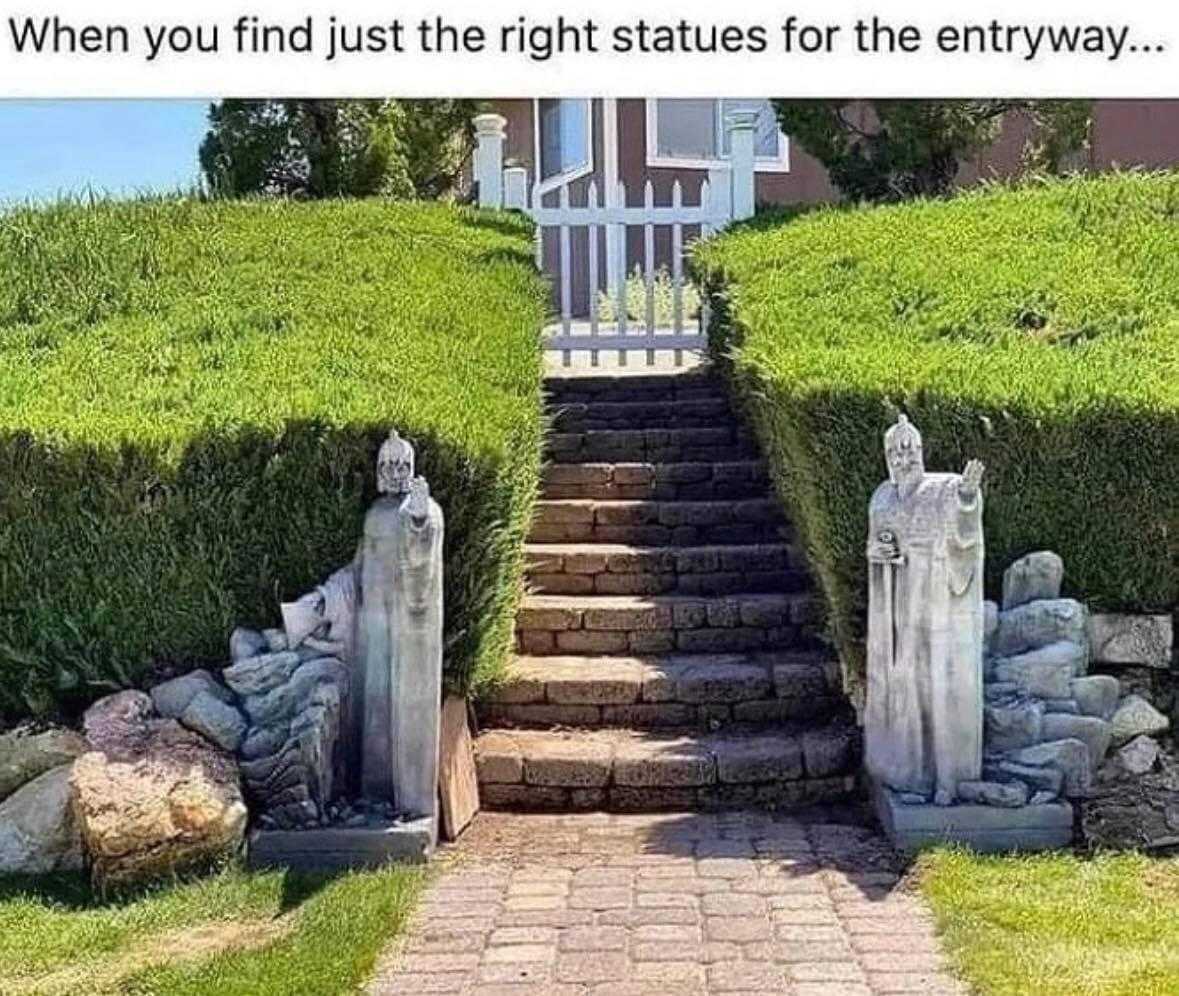 there is a stone stairway leading to a garden with statues