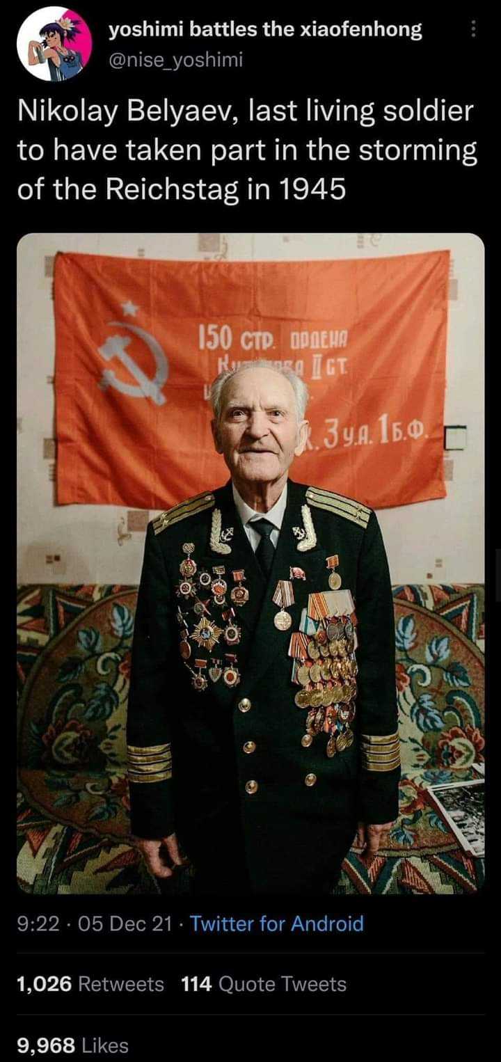 a close up of a person in a military uniform standing in front of a flag