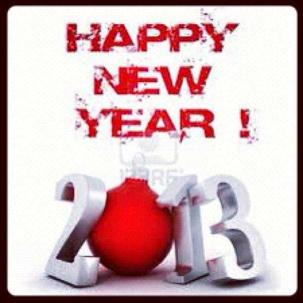 a red ball sitting on top of a white sign with the words happy new year