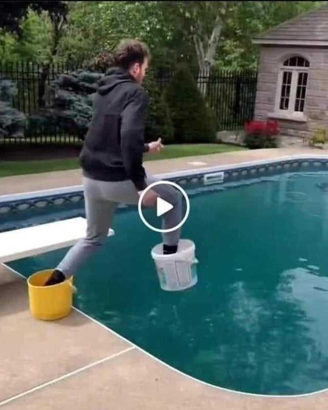 woman jumps into a pool to catch a bucket