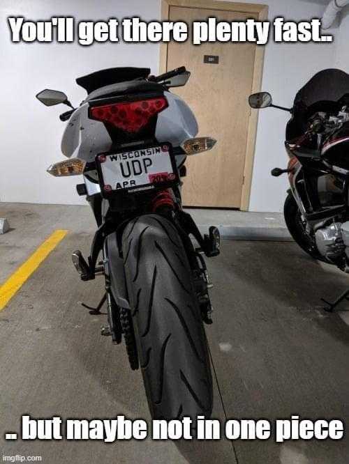 there is a motorcycle parked in a garage with a license plate on it