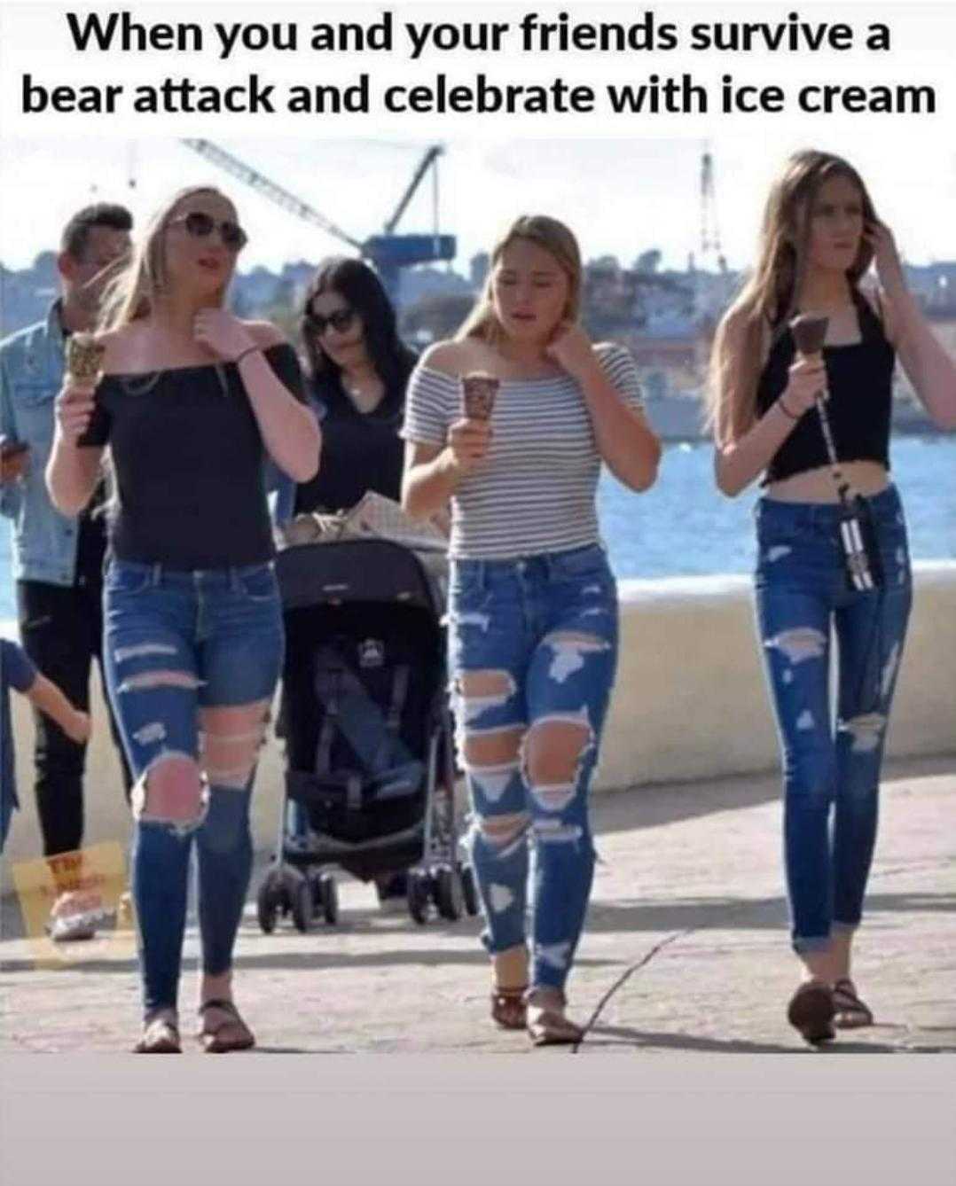 three women walking down a sidewalk with a baby carriage in the background