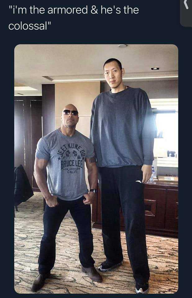 man standing next to a man in a room