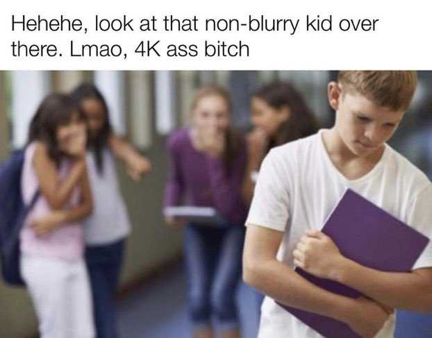 boy holding a book in front of a group of girls