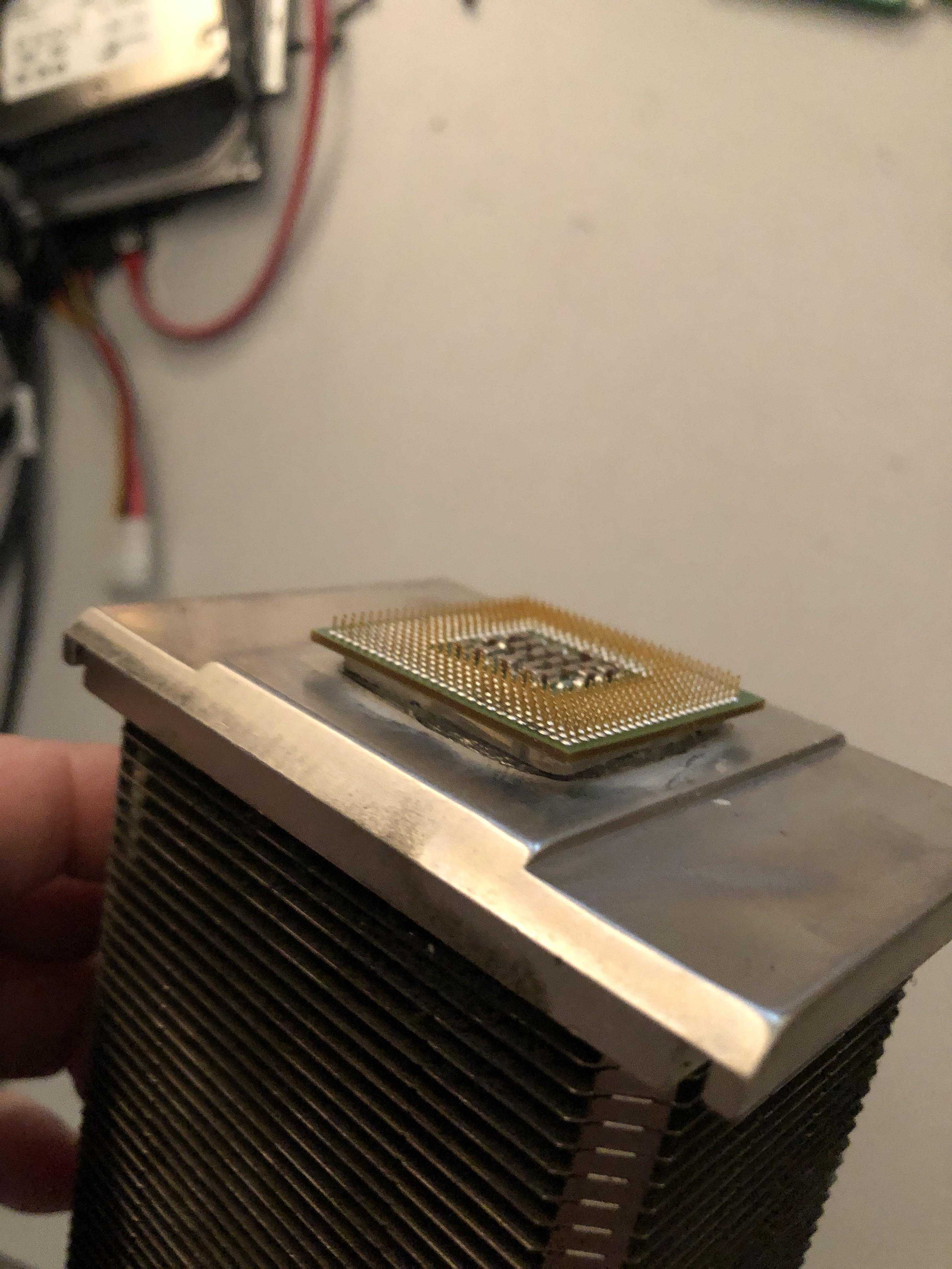 someone is holding a cpu in their hand and it is in a room