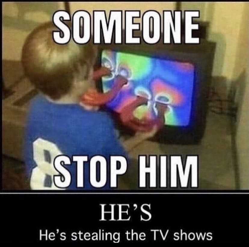 there is a kid that is playing with a tv