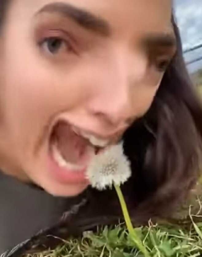 woman with a flower in her mouth and a black jacket