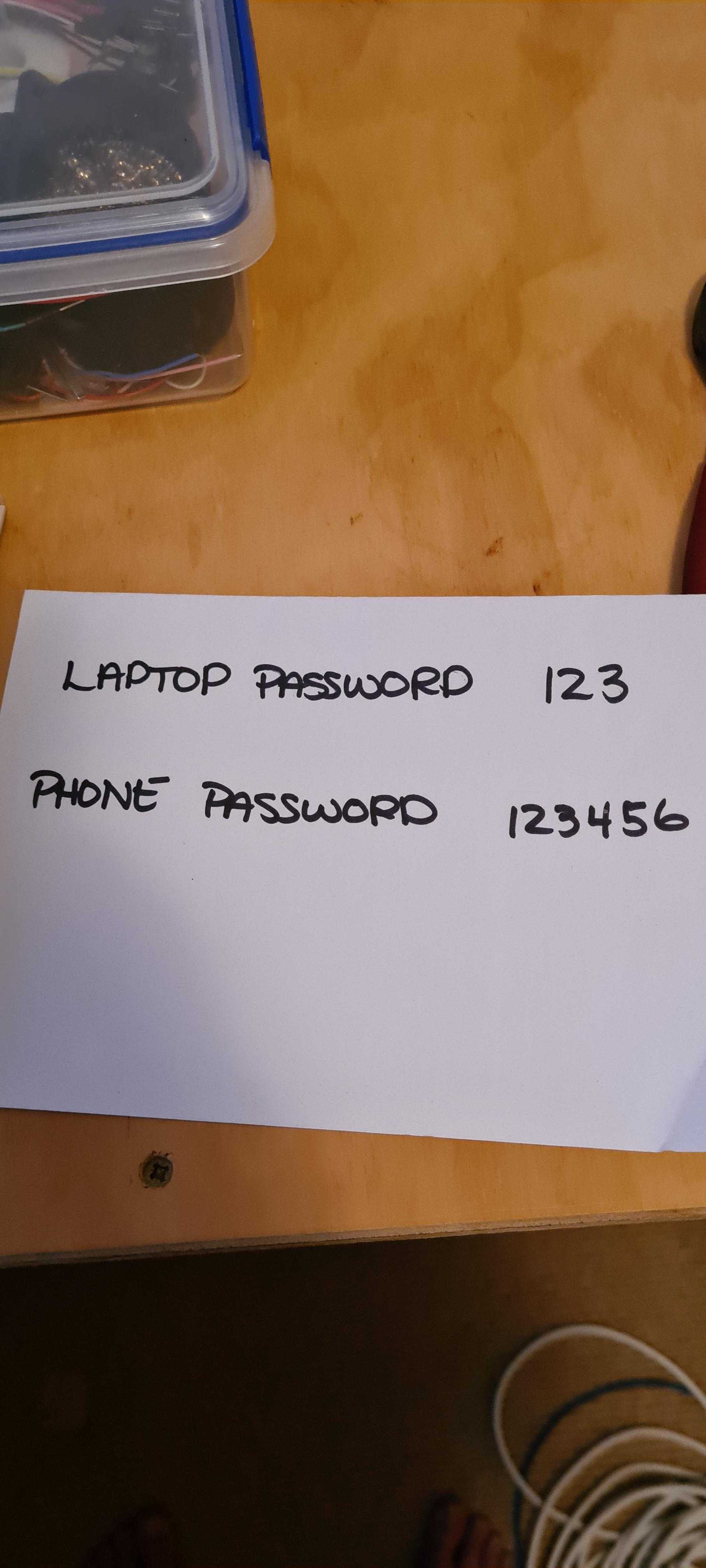 there is a sign that says laptop password on a table