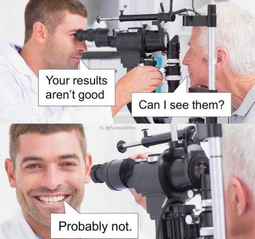 man looking through a camera lens at a doctor