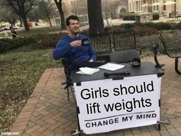 man sitting at a table with a sign that says girls should lift weights change my mind