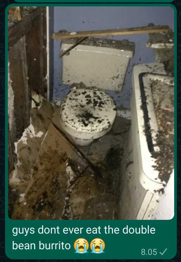 toilet in a bathroom with a dirty floor and walls